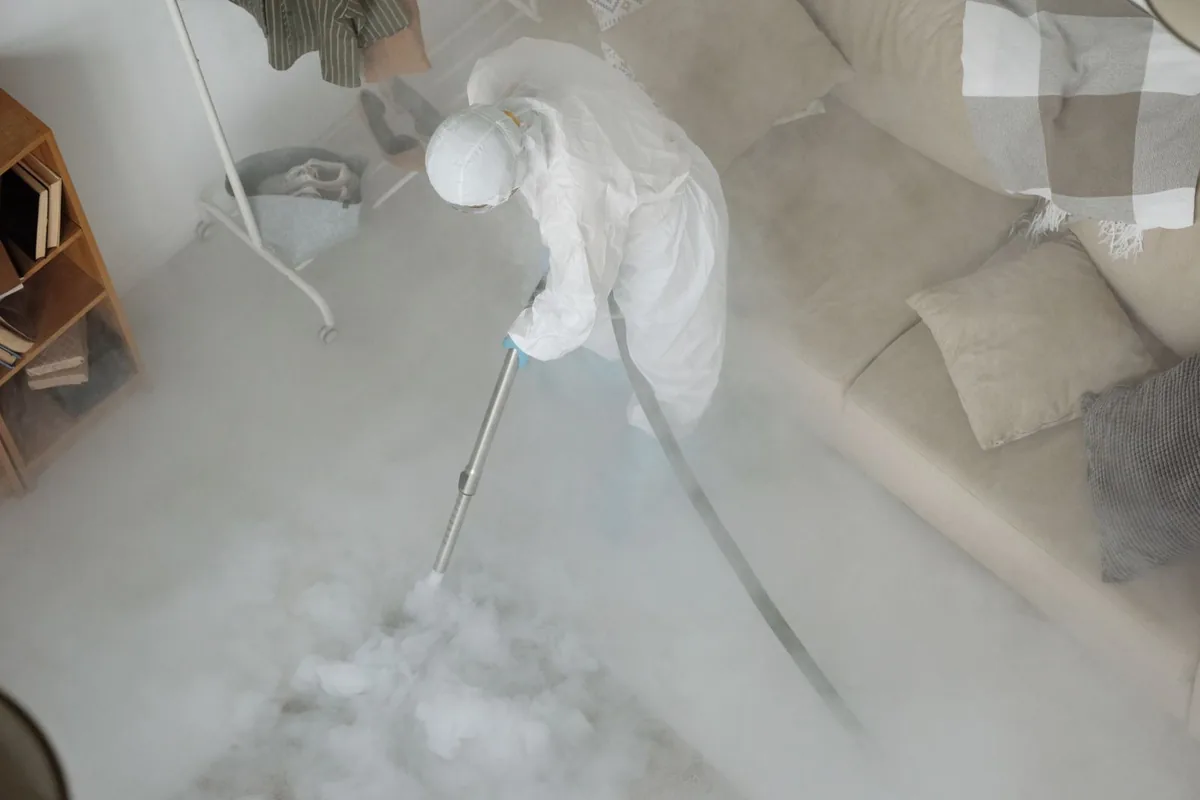 Biohazard cleanup technician in protective equipment, Wrightsville, AR
